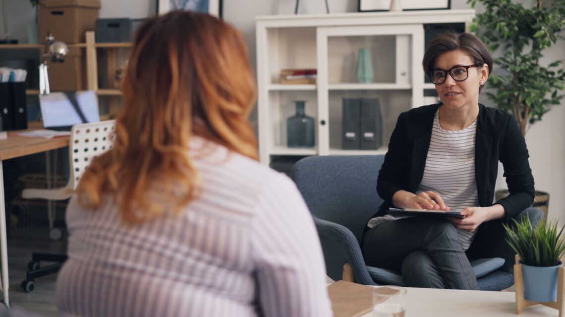 Physician consulting with patient about GLP-1 medical weight loss program in a Utah clinic office